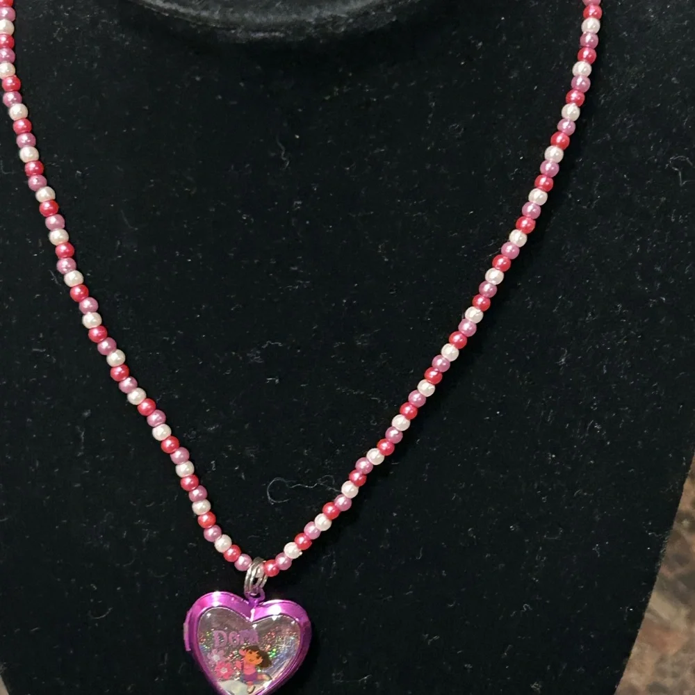 Pink and white beaded necklace with Dora the Explorer locket
